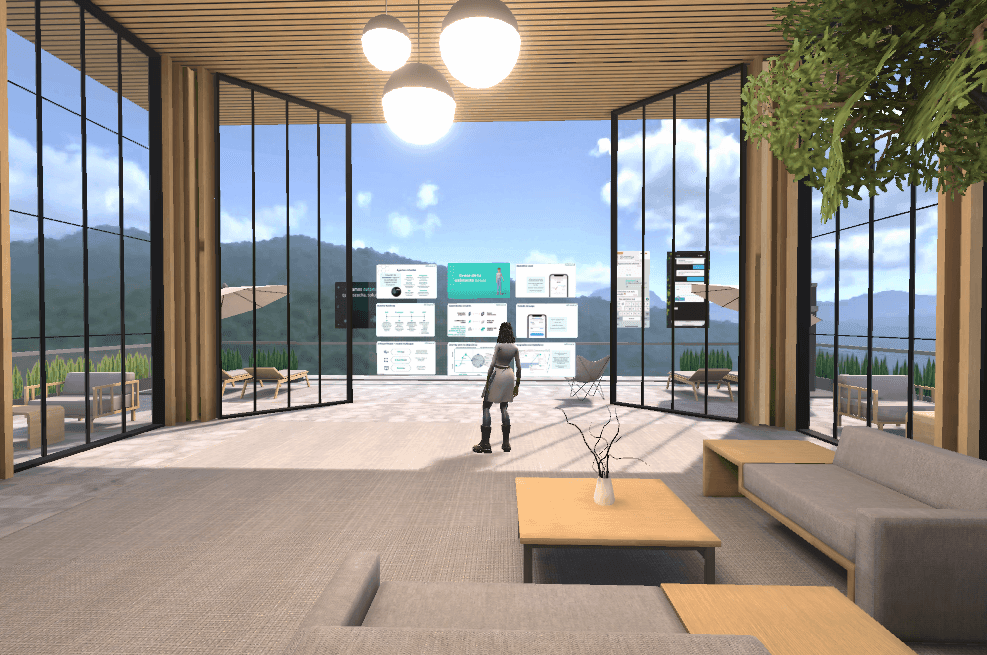 Person in a modern, spacious room with large windows, interactive screens, and mountain views.