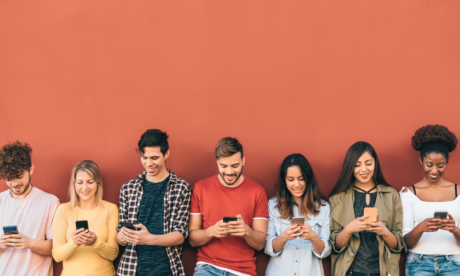 Group young people using mobile smartphone outdoor - Millennial generation having fun with new trends social media apps - Youth technology addicted - Red background